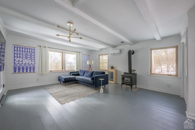 living area featuring wood finished floors, baseboards, an AC wall unit, beam ceiling, and a wood stove