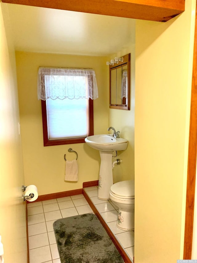 bathroom featuring sink, tile patterned flooring, and toilet