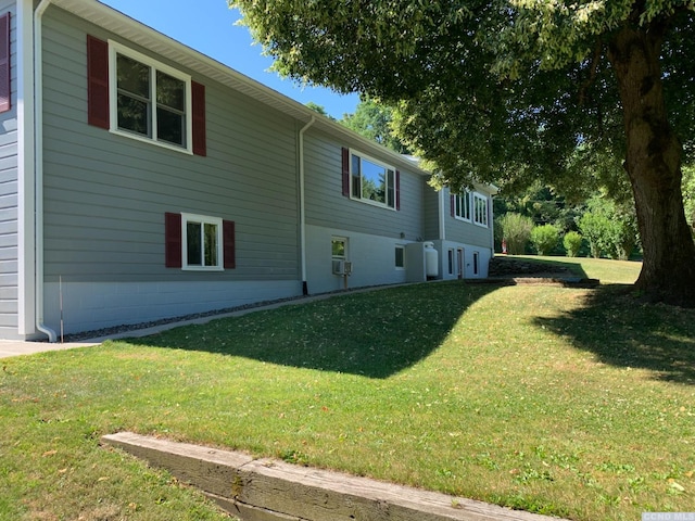 view of side of home featuring a yard