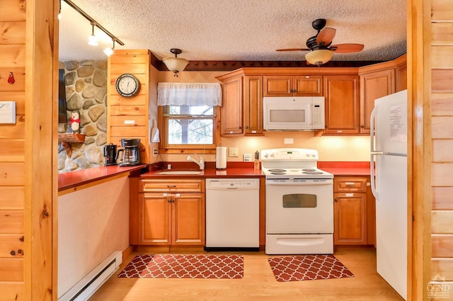 kitchen with rail lighting, white appliances, ceiling fan, a baseboard heating unit, and sink