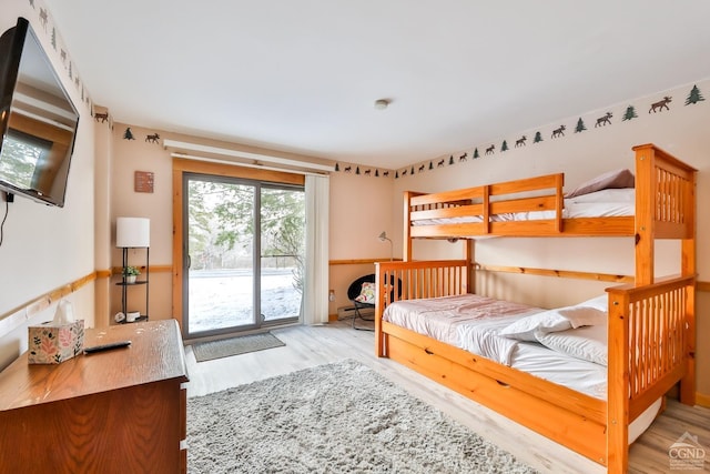 bedroom with light hardwood / wood-style floors and access to outside