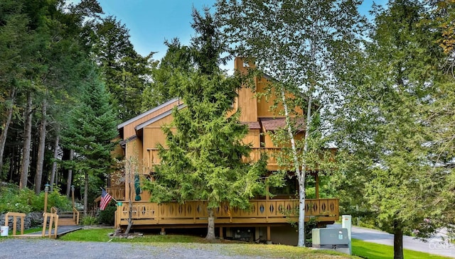 back of property featuring a wooden deck