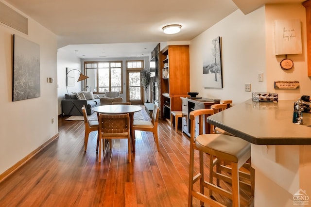 dining area with hardwood / wood-style floors