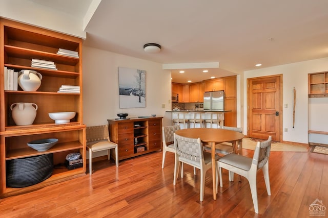 dining space with light wood-type flooring