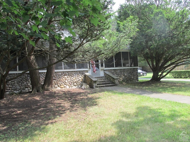 view of yard with a sunroom