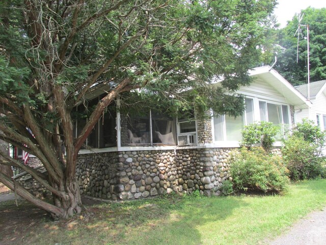 view of front of home with a sunroom and a front yard