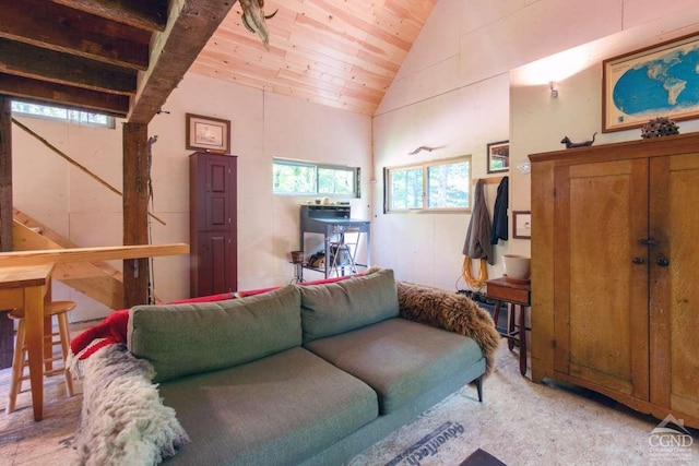 living room with wooden ceiling and high vaulted ceiling