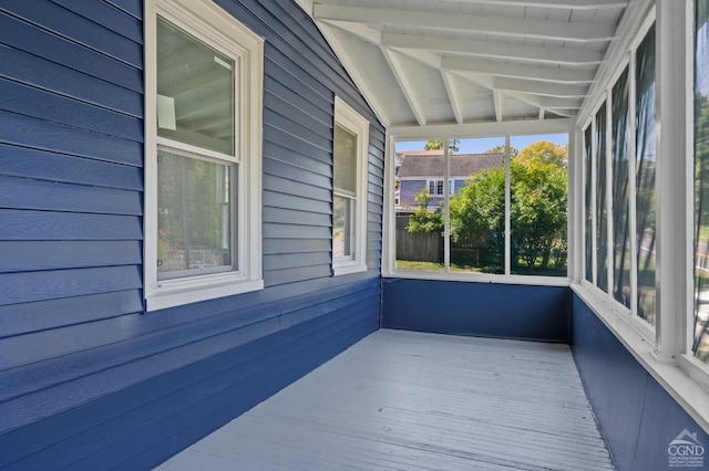 unfurnished sunroom featuring vaulted ceiling