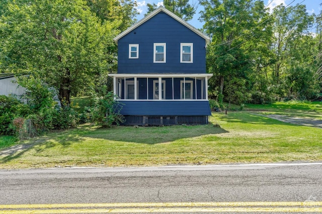 view of front of home featuring a sunroom and a front lawn