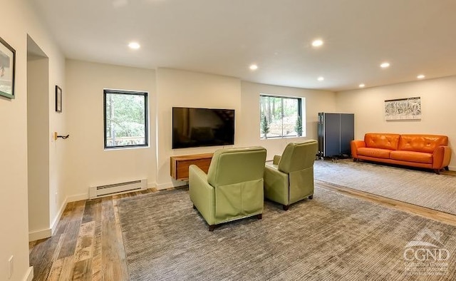 living room featuring baseboard heating and wood-type flooring