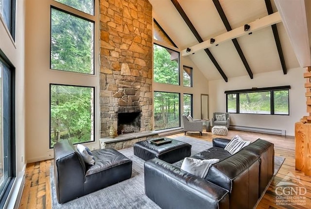 living room with a fireplace, light hardwood / wood-style flooring, high vaulted ceiling, and a baseboard heating unit