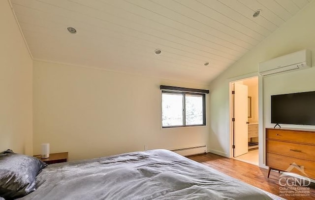 bedroom featuring lofted ceiling, ensuite bath, baseboard heating, light hardwood / wood-style floors, and a wall unit AC