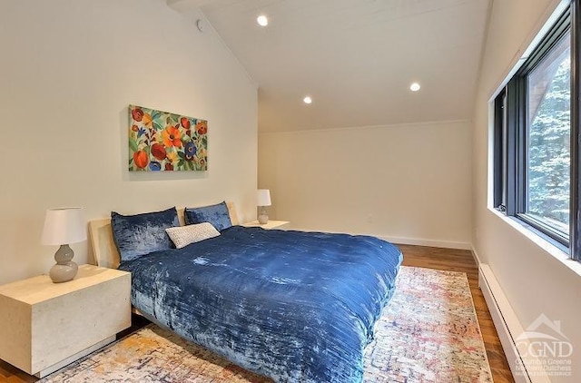 bedroom with hardwood / wood-style flooring, lofted ceiling, and baseboard heating