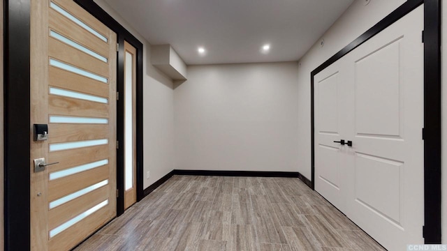 entryway with recessed lighting, light wood-type flooring, and baseboards