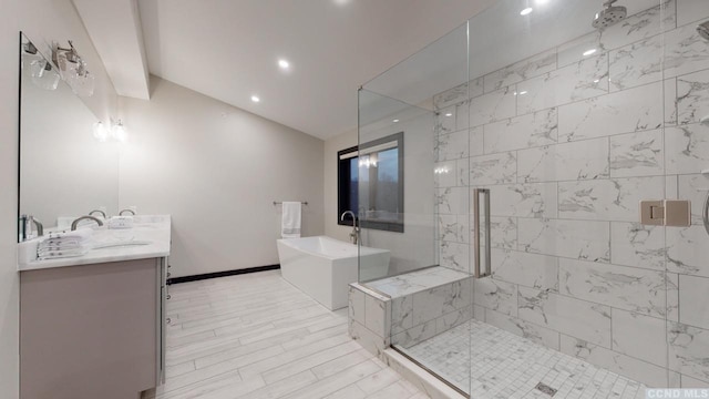 bathroom with double vanity, a soaking tub, baseboards, and a stall shower