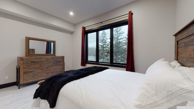 bedroom featuring light wood-type flooring, baseboards, and recessed lighting