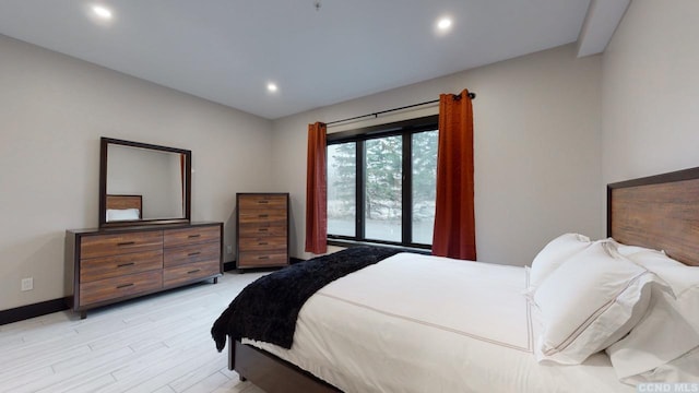 bedroom featuring baseboards, light wood-type flooring, and recessed lighting