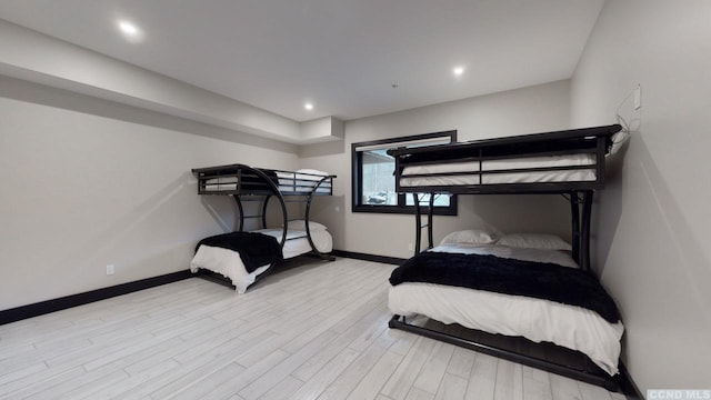 bedroom with recessed lighting, light wood-style flooring, and baseboards