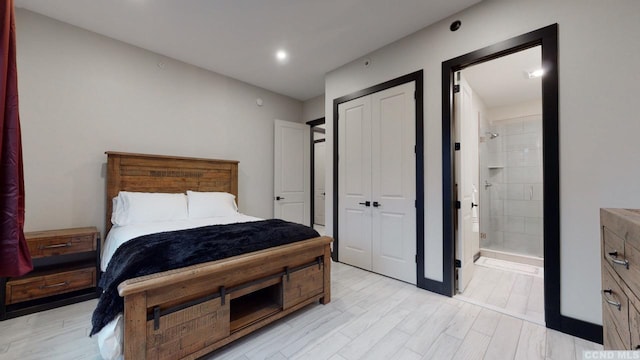 bedroom featuring a closet, connected bathroom, and light wood-style floors