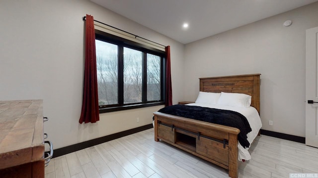 bedroom featuring light wood-type flooring, baseboards, and recessed lighting