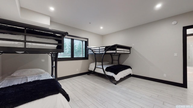 bedroom featuring light wood-type flooring, baseboards, and recessed lighting