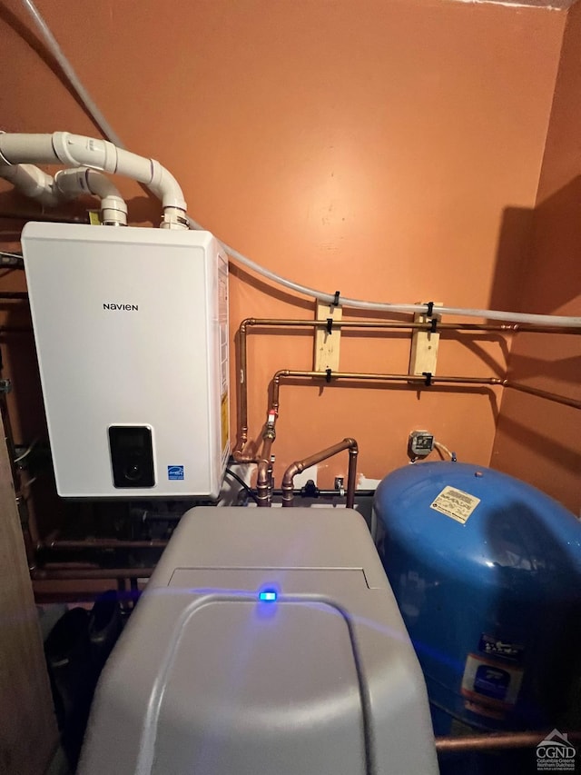 utility room featuring tankless water heater