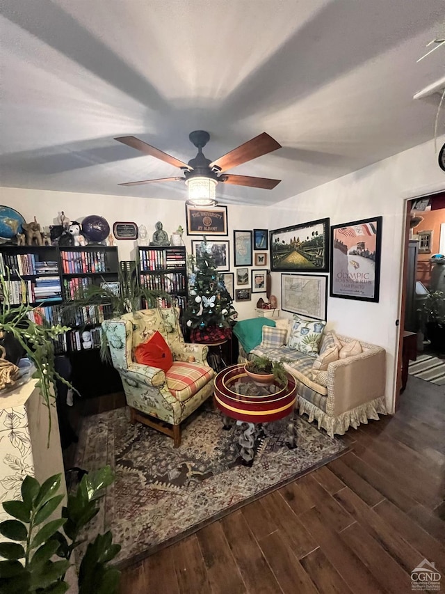 sitting room with wood-type flooring and ceiling fan