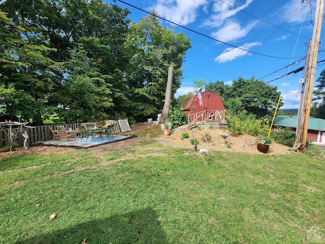 view of yard featuring a patio area and an outdoor structure