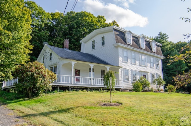 view of front of home with a porch and a front lawn