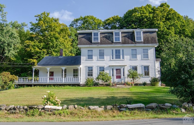 colonial house with covered porch and a front yard