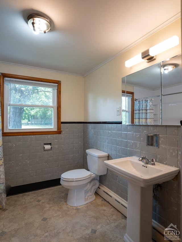 bathroom with a sink, baseboard heating, ornamental molding, and toilet