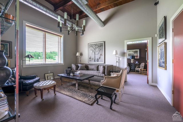 carpeted living room featuring beamed ceiling, a towering ceiling, an inviting chandelier, and wooden ceiling