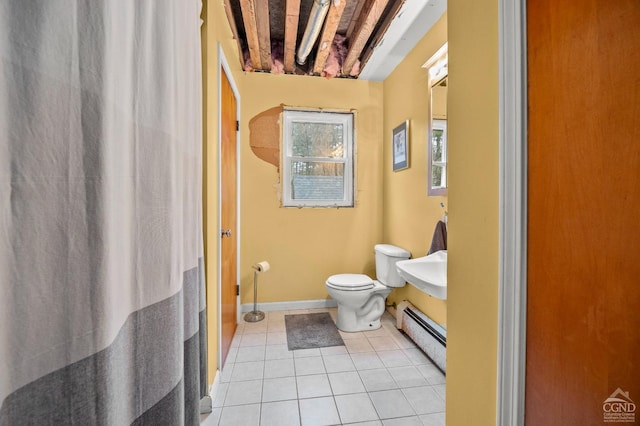 bathroom featuring tile patterned flooring, toilet, and a baseboard heating unit