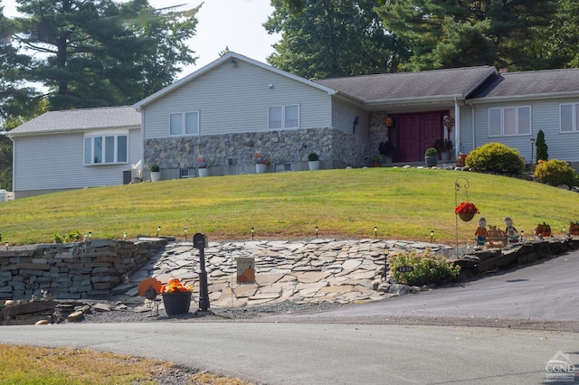 single story home with central AC and a front yard