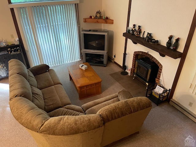 living room featuring a baseboard heating unit, carpet floors, and a wood stove