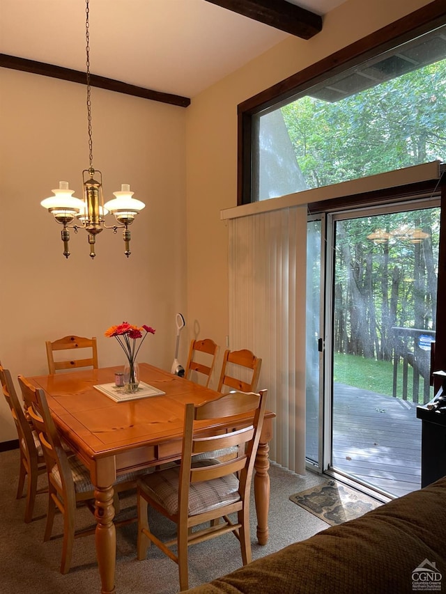 carpeted dining room featuring beamed ceiling and an inviting chandelier