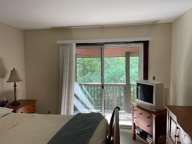 bedroom with carpet floors, access to outside, and multiple windows