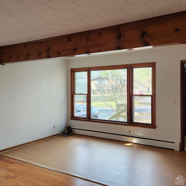 unfurnished room with light wood-type flooring and baseboard heating