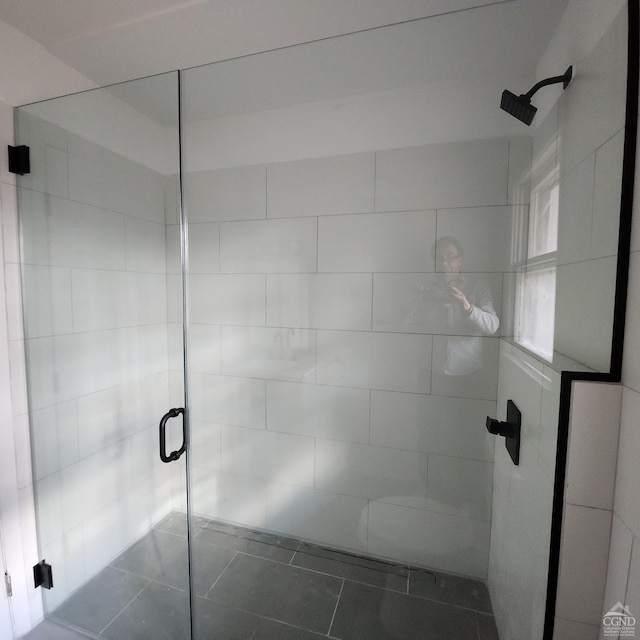 bathroom featuring tile patterned floors and a shower with door