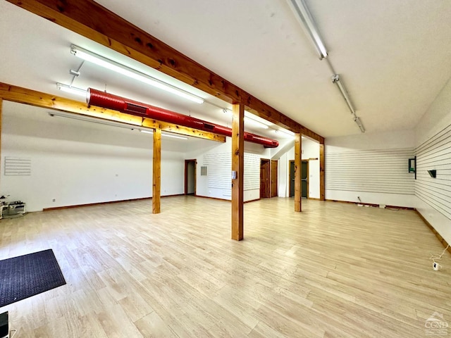 basement with light hardwood / wood-style floors