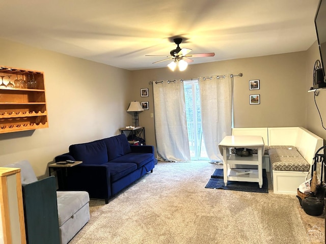 living room with ceiling fan and light colored carpet