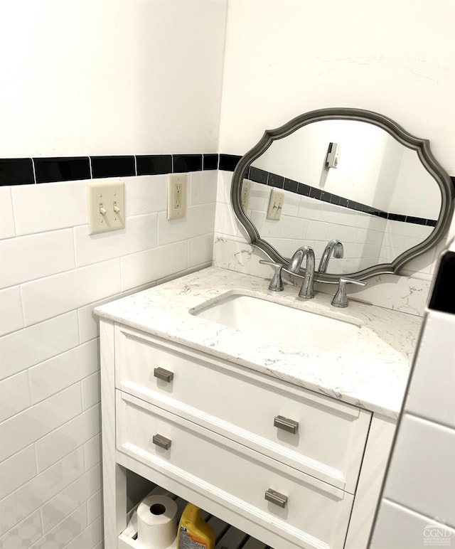 bathroom featuring backsplash, vanity, and tile walls