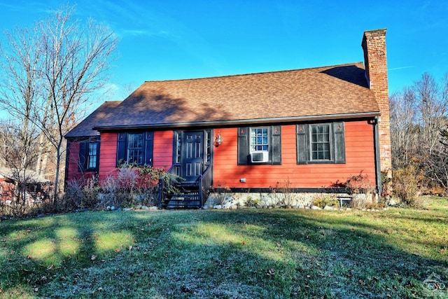 view of front of house with cooling unit and a front lawn