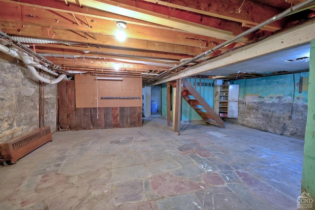 basement featuring radiator heating unit