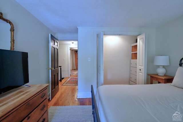 bedroom featuring light wood-type flooring and a closet