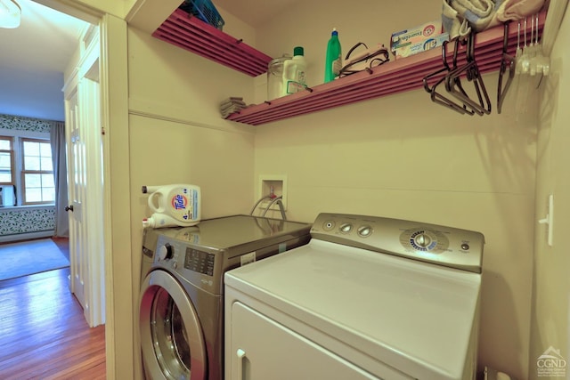 laundry area featuring washer and dryer and wood-type flooring