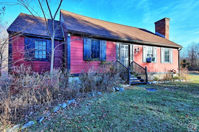 view of front of property with cooling unit and a front yard