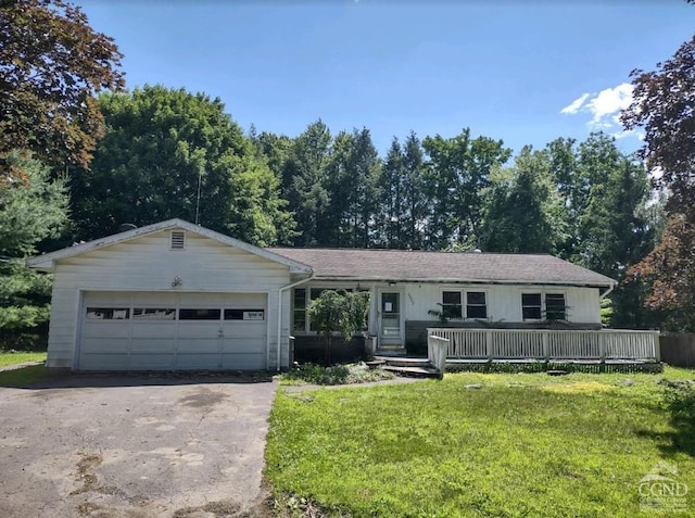 ranch-style home with a garage and a front lawn