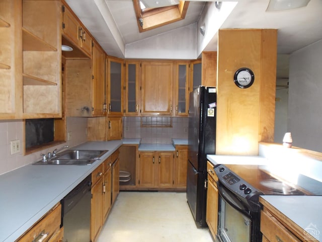 kitchen with black appliances, lofted ceiling with skylight, sink, and tasteful backsplash