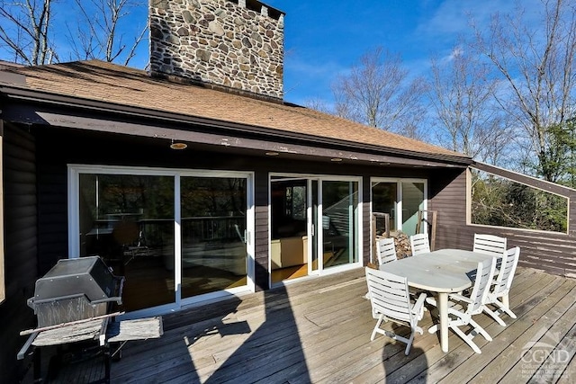 wooden deck featuring a grill